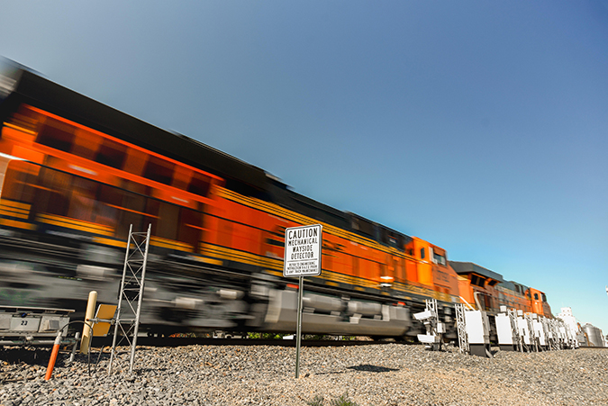 A BNSF train passes by wayside detectors.