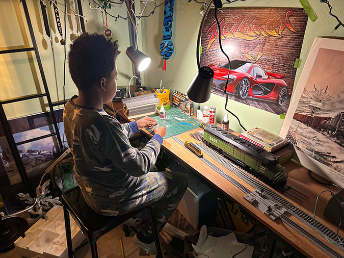 Daecian working on a model railroad layout. Daecian working on a model railroad layout.