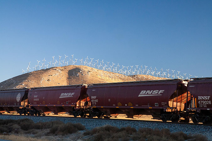 Grain hoppers passing a wind farm Grain hoppers passing a wind farm