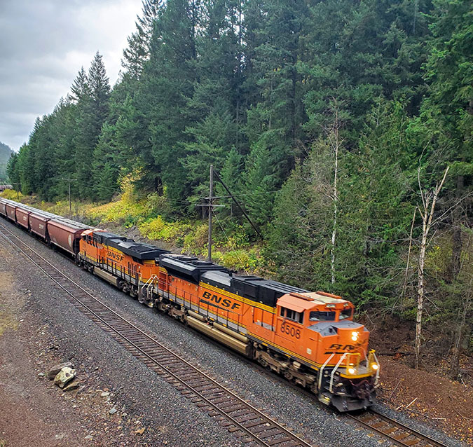 BNSF train passing by Kootenai Falls, Montana